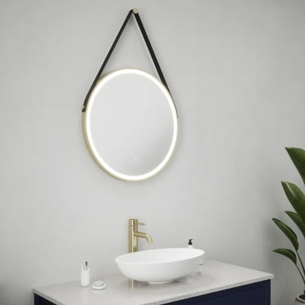 Close up product lifestyle image of the Zelda Round Colour Changing LED Mirror with Brushed Gold Trim & Strap